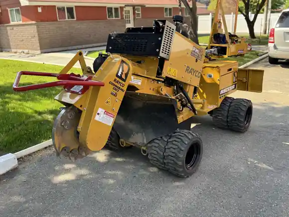 A stump grinder set up on a driveway